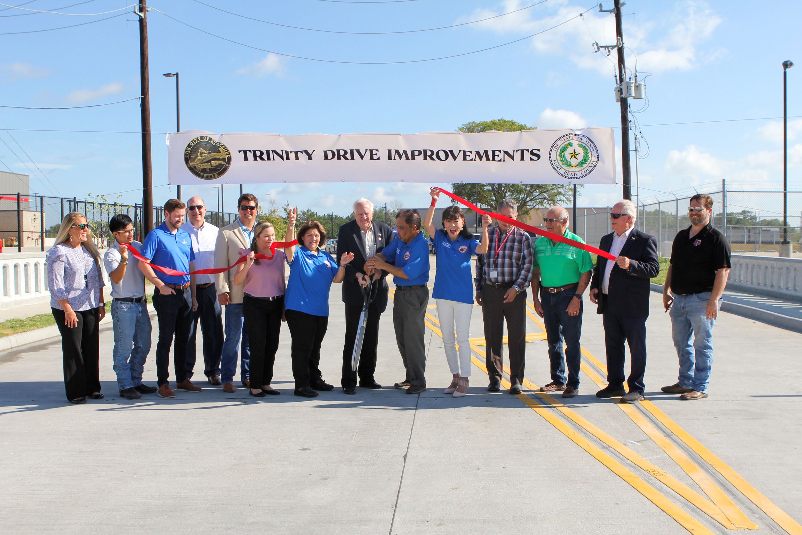 Mayor Willis Cutting the Ribbon Surrounded by People