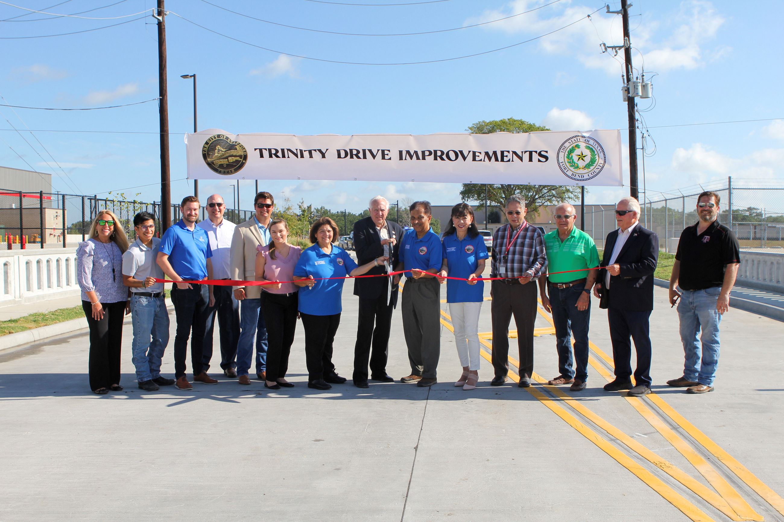 Group photo of everyone in front of the Trinity Drive Sign 